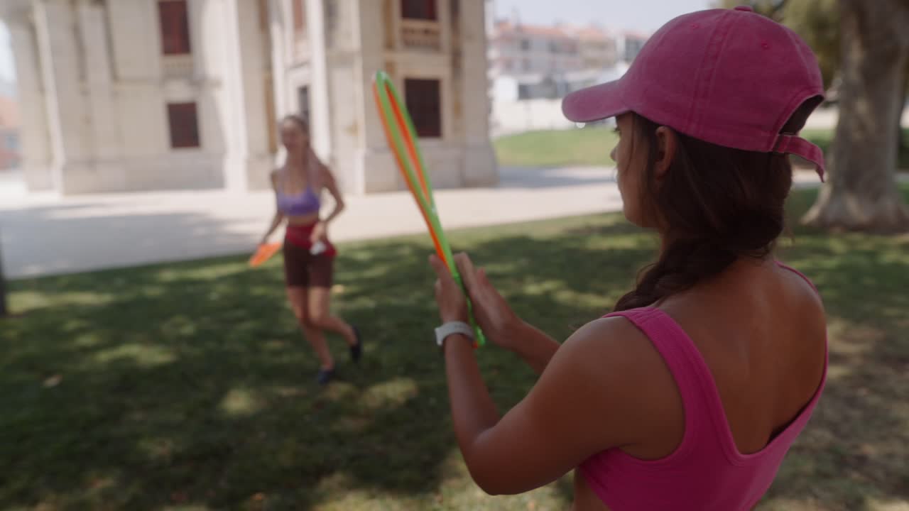 Women playing tennis in the park