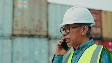 worker on a phone call at a shipping port