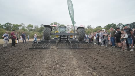 demonstration of agricultural machinery at an exhibition. tractors operate in the field, showcasing their capabilities and performance in action