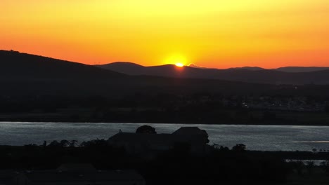 Maguelone-cathedral-on-island-and-lagoon-in-southern-France-during-sunset,-Aerial-dolly-right-shot