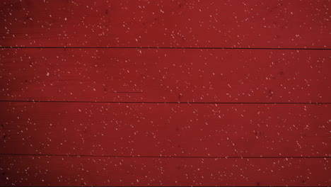 animation of winter scenery snow falling against red wooden boards