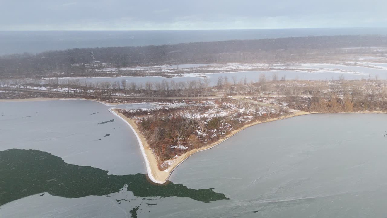 Aerial shot of snow falling on Presque Isle State Park.