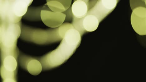 video of flickering white and green bokeh spots of light with copy space