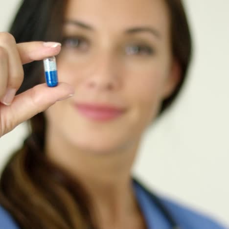 doctor or nurse holding up a capsule