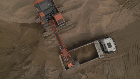 Bagger-Füllt-Einen-LKW-Voller-Sand