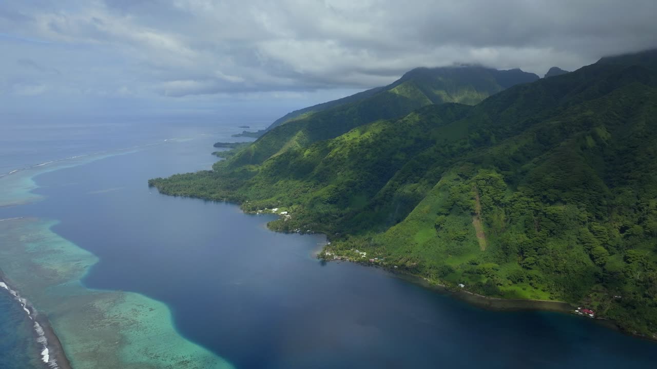 North Shore Vallee de Taitira Bay Tahiti French Polynesia aerial drone village town Teahupoo passe coral barrier reef Vaitepiha River Taravao Taiarapu South Pacific Ocean morning blue sky forward pan