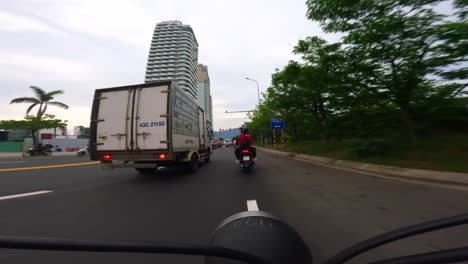 navigating the lively võ nguyên giáp street near my khe beach in da nang, vietnam - pov