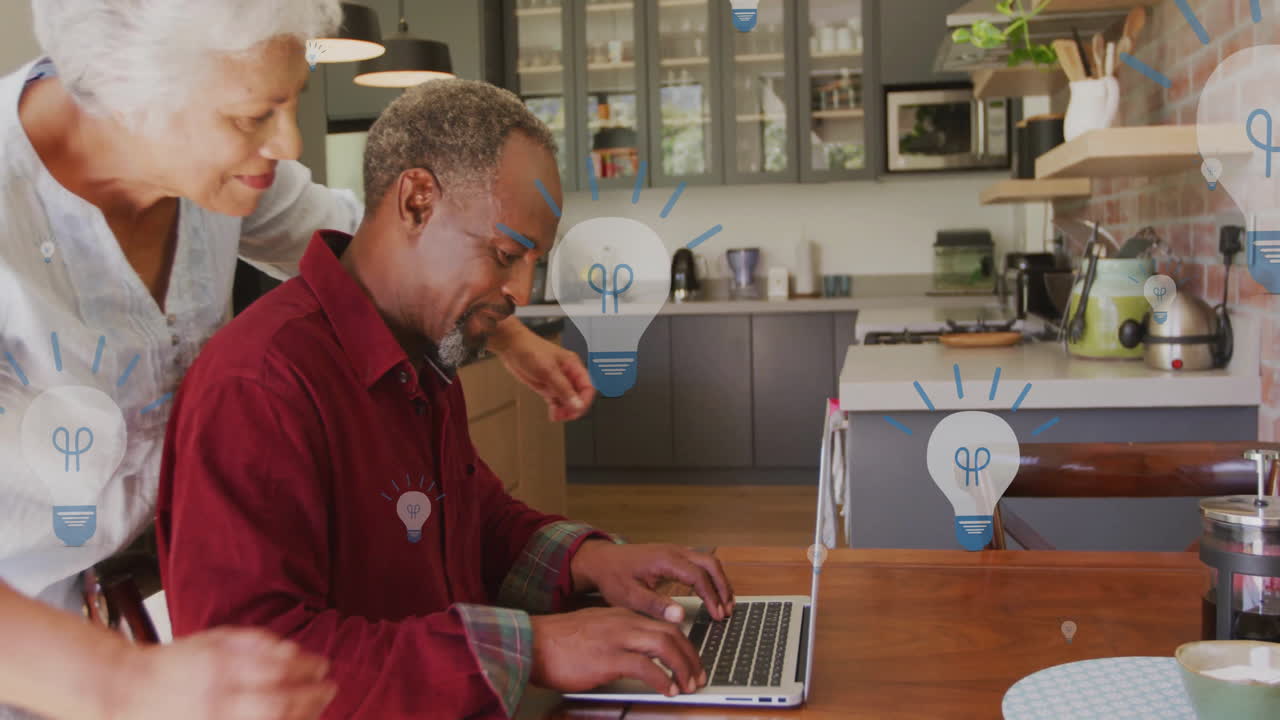 Animation of lightbulb icons over senior biracial couple embracing