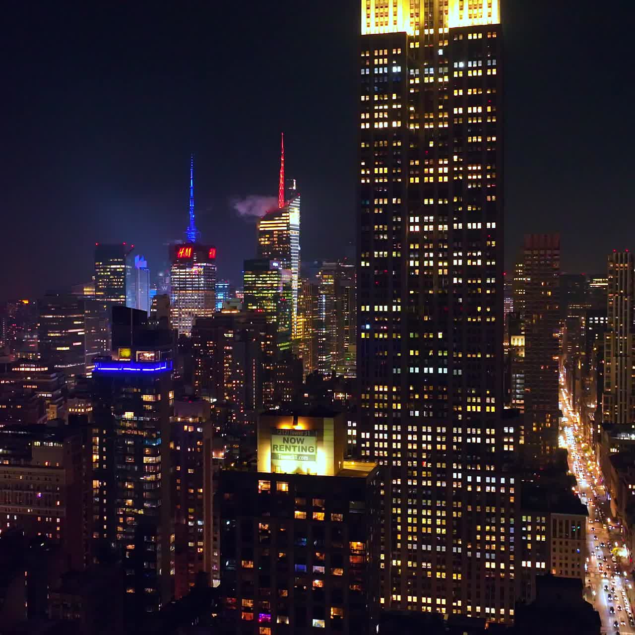 Gorgeous tops of the glamorous skyscrapers in New York. Wonderful architecture of metropolis at night time