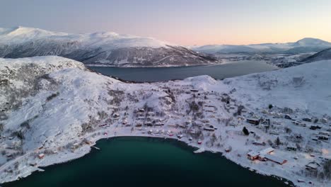 stunning aerial view of norwegian fjords and ersfjordvegen village with snowy mountains and blue sea