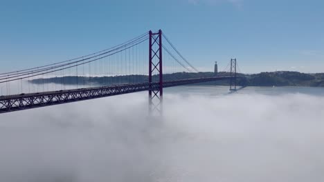 drone shot of ponte 25 abril, in lisbon. in fog.