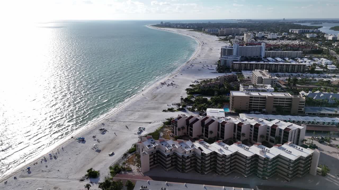 warm waves from the Gulf of Mexico waters lap on the beautiful white sand beaches of Siesta Key beach, Florida