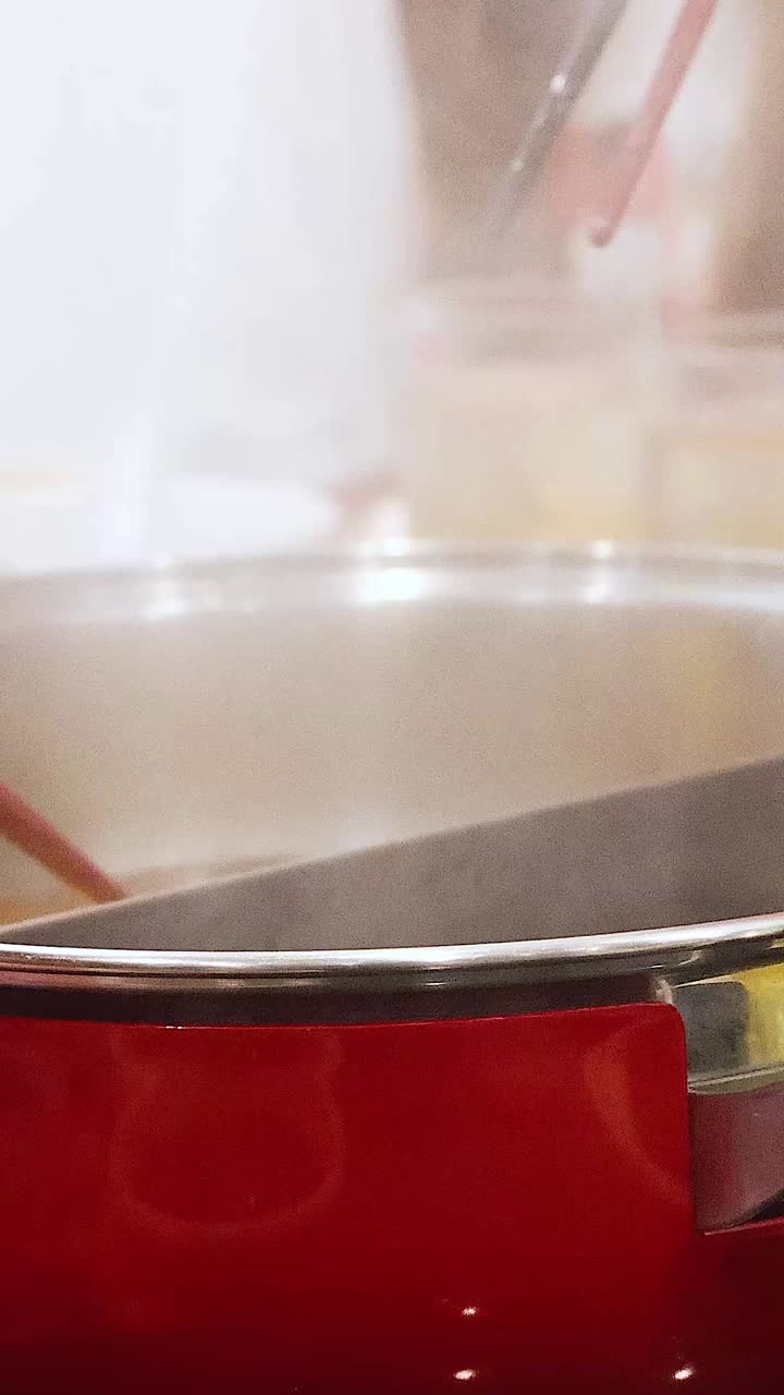 Friends cooking and sharing hotpot together