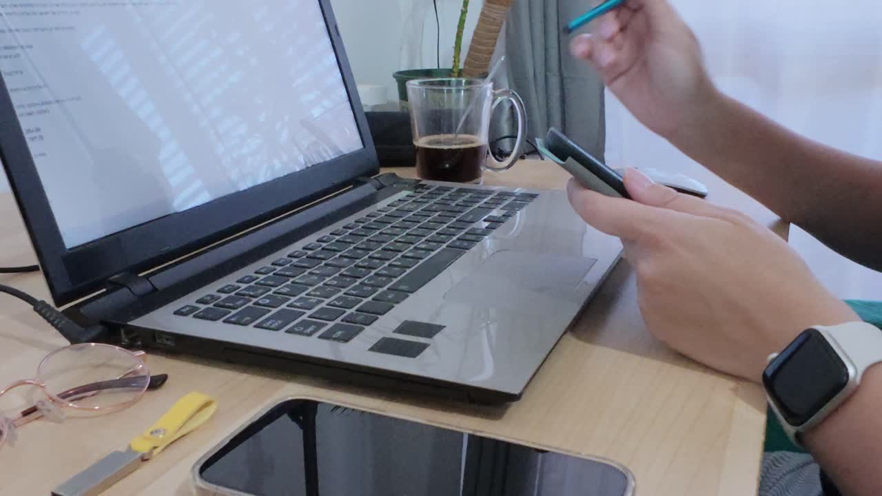 Person working remotely, using a tablet for documents while also on a laptop