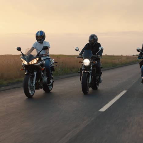 A-group-of-bikers-rides-on-the-highway-in-the-evening-at-sunset-1