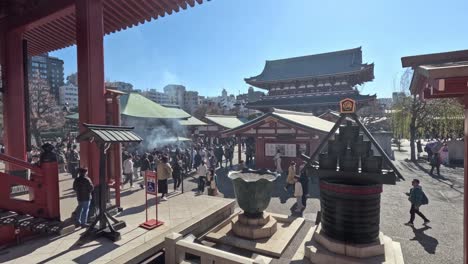 crowds moving through a historic temple complex