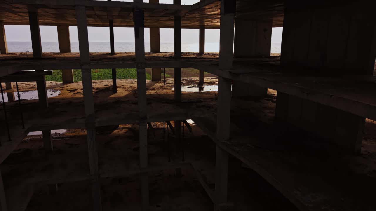 Abandoned structure on the coast showcasing unfinished construction