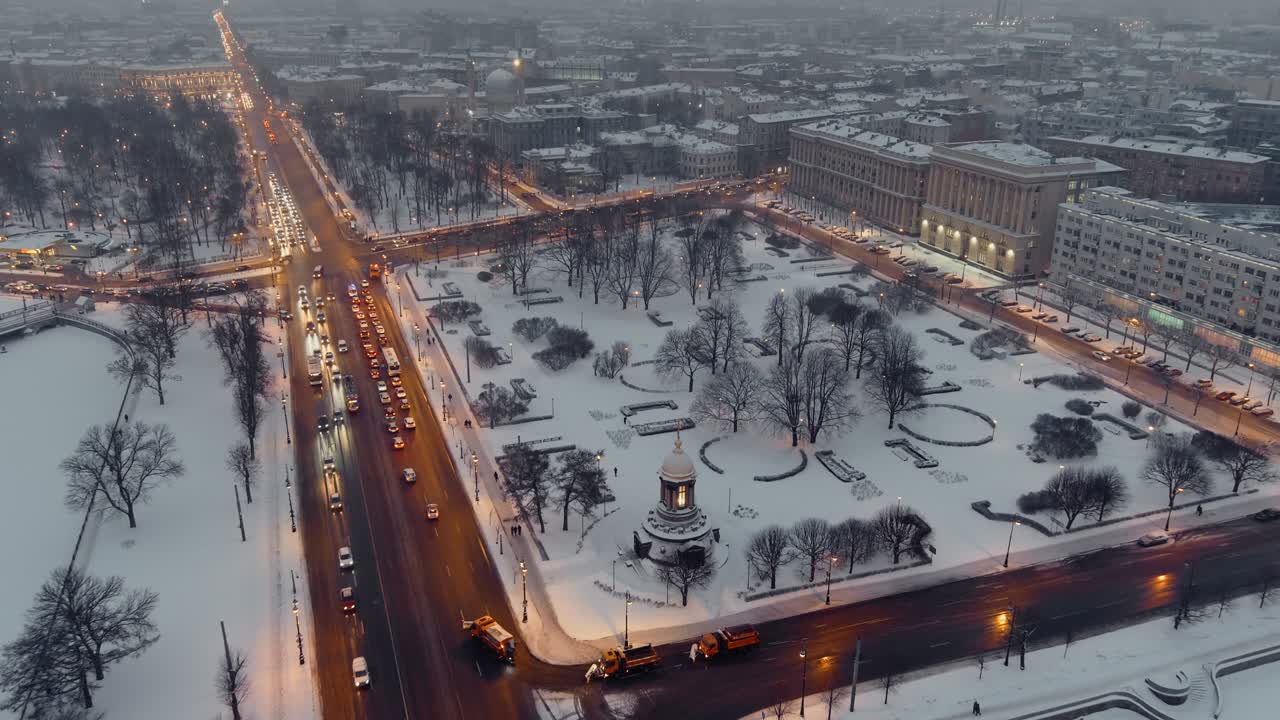 Night illumination of the main roadway of the artery of the Petrograd district of St. Petersburg at dusk, the Trinity Chapel in the snow-covered Square, the Cathedral Mosque in the background