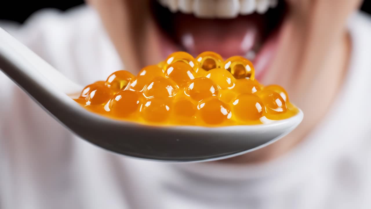 Eating orange caviar with a spoon