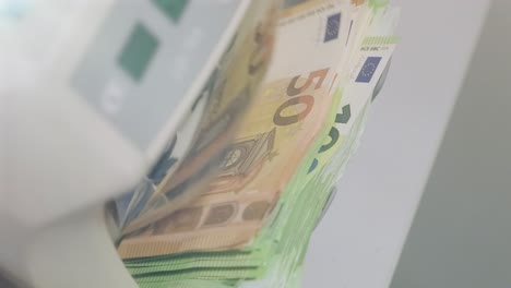 the calculating machine counts euro bills thousand euro. new bills