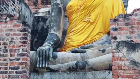 close-up of buddha statue with yellow robe