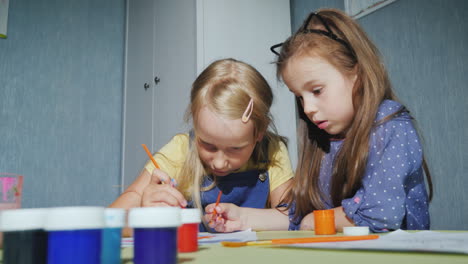 two girls paint together with watercolors 4k video