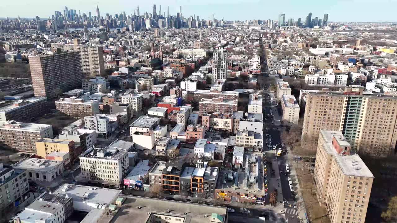 Horizontal drone side-tracking shot over Varet Street in Brooklyn, capturing New York’s vibrant streets, historic buildings, and dynamic cityscape with smooth lateral aerial movement.