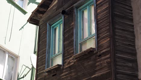 old wooden house facade with blue windows