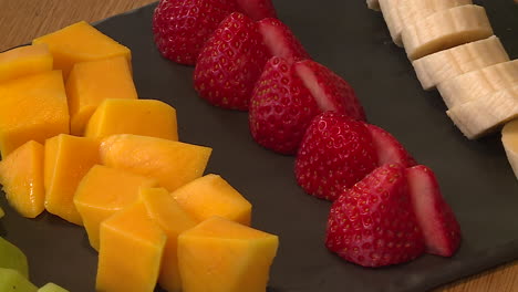 fruit platter with mango, strawberries, bananas and kiwi