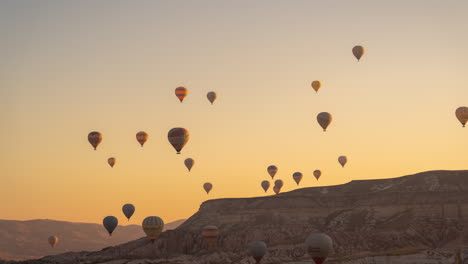 time lapse of hot air balloons in cappadocia, turkey at morning flying above hills