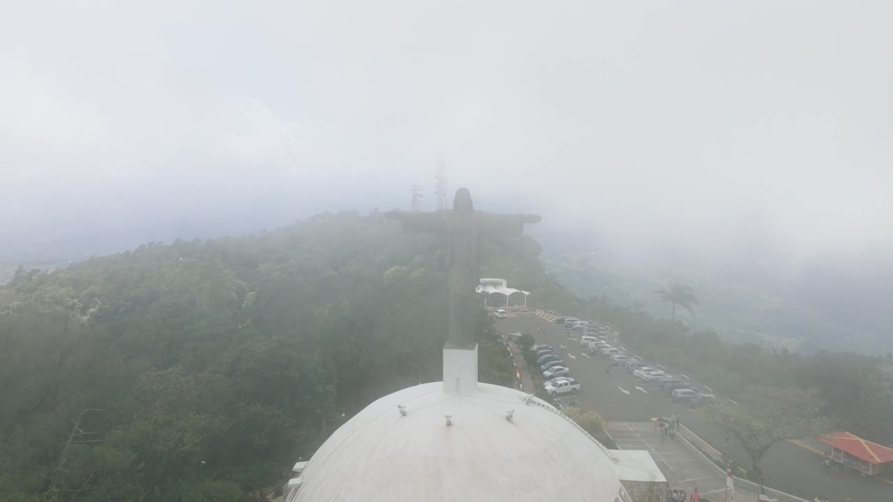 Aerial View of Cristo Redentor Statue Above Puerto Plata, Dominican Republic on Foggy Day, Drone Shot