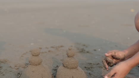 Detail-Shot-of-Unrecognizable-Hands-Playing-with-Sand-at-Tropical-Indian-Beach-near-the-sea