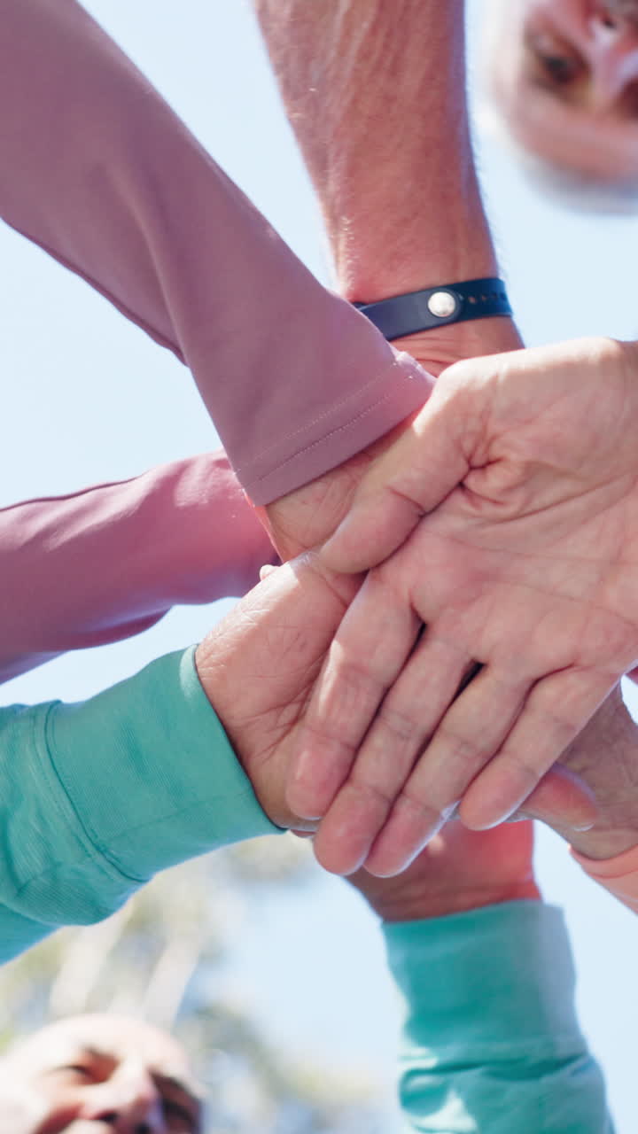 Low Angle View of Hands Stacking for Teamwork and Unity