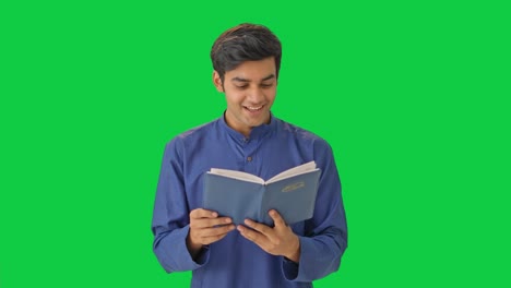 happy indian man reading a book green screen