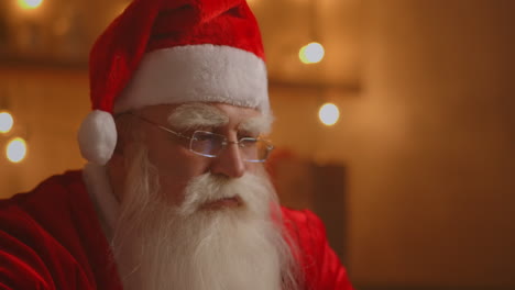 Jolly-Santa-working-on-a-laptop-computer.-Santa-Clause-using-laptop-close-up.-High-quality-4k-footage