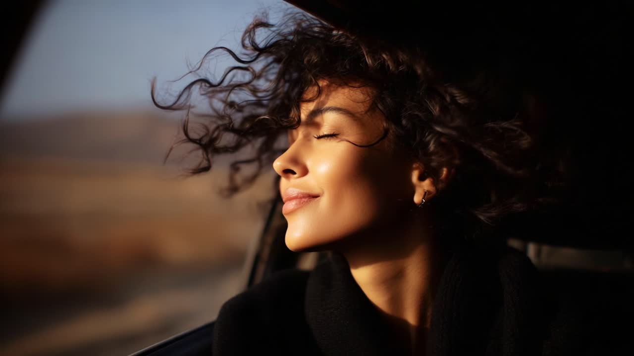 A Joyful Woman Embraces the Wind with a Smile as She Enjoys an Adventurous Drive, Hair Dancing in the Breeze, Capturing the Essence of Freedom and Happiness in Nature