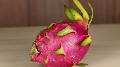 dragon fruit rotates on a wooden surface