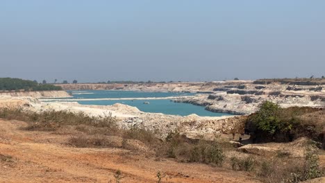 static shot of blue lake or pond formed by mining limestone for cement