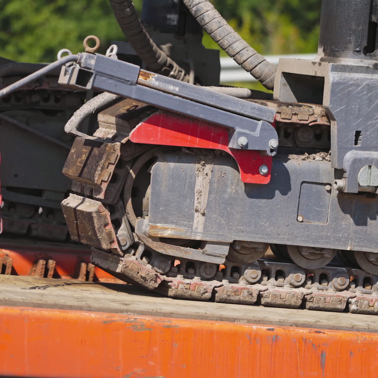 Caterpillar excavator in motion. Close-up of a caterpillar crawler machine that moves on metal support. Slow motion.