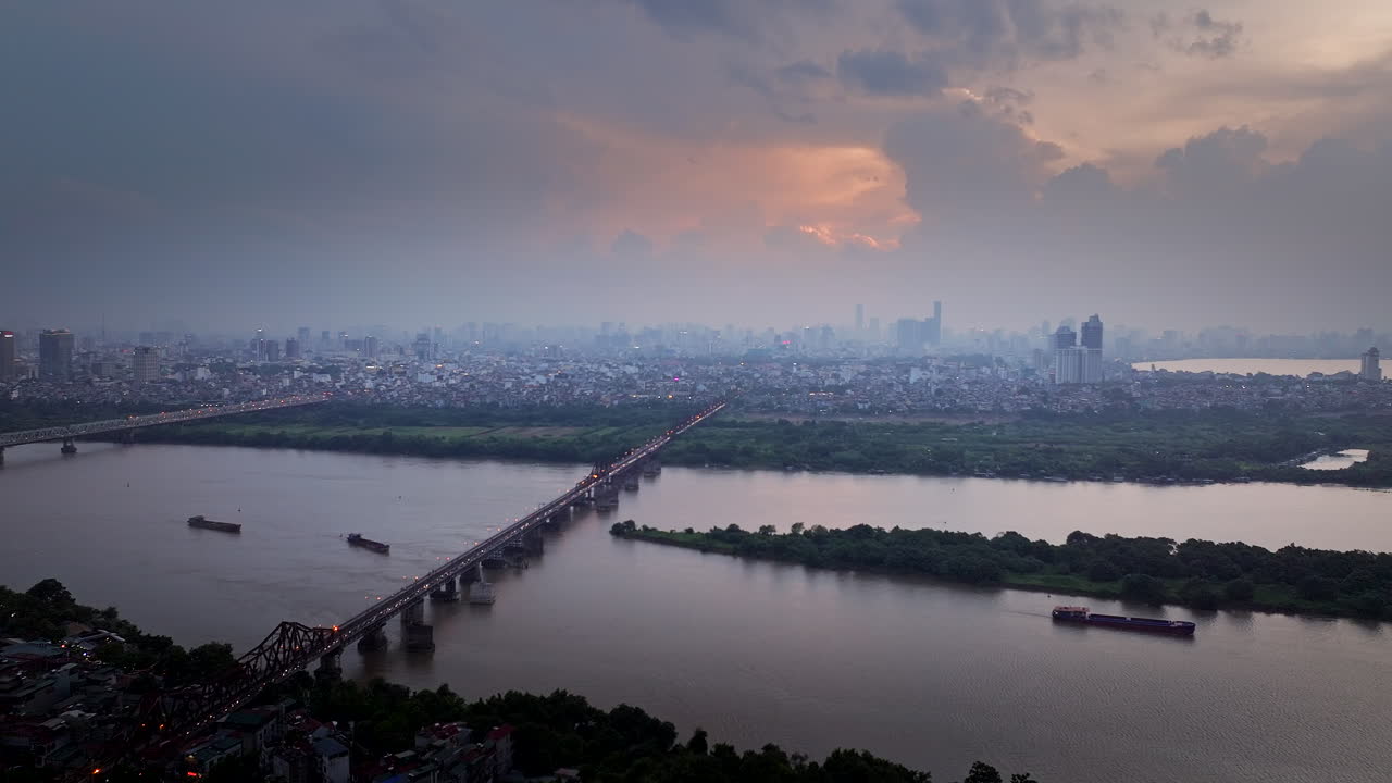 Long Bien bridge spanning Red River in Hanoi Vietnam, twilight aerial view