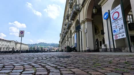 people walking along a cobblestone street