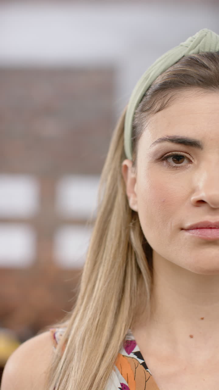 Vertical video of portrait of happy caucasian businesswoman in office in slow motion