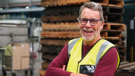 worker standing with arms crossed in factory