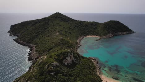 Forward-shot-over-green-Island-surrounded-by-blue-water-and-white-beaches