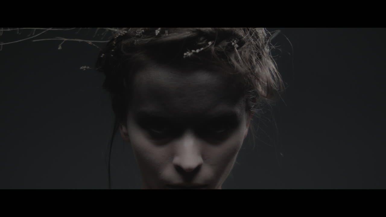 A woman dressed as mother nature rise her head