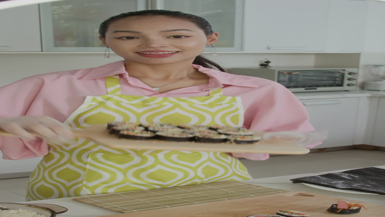 Vertical of Vlogger Tasting Homemade Gimbap on Camera at Kitchen