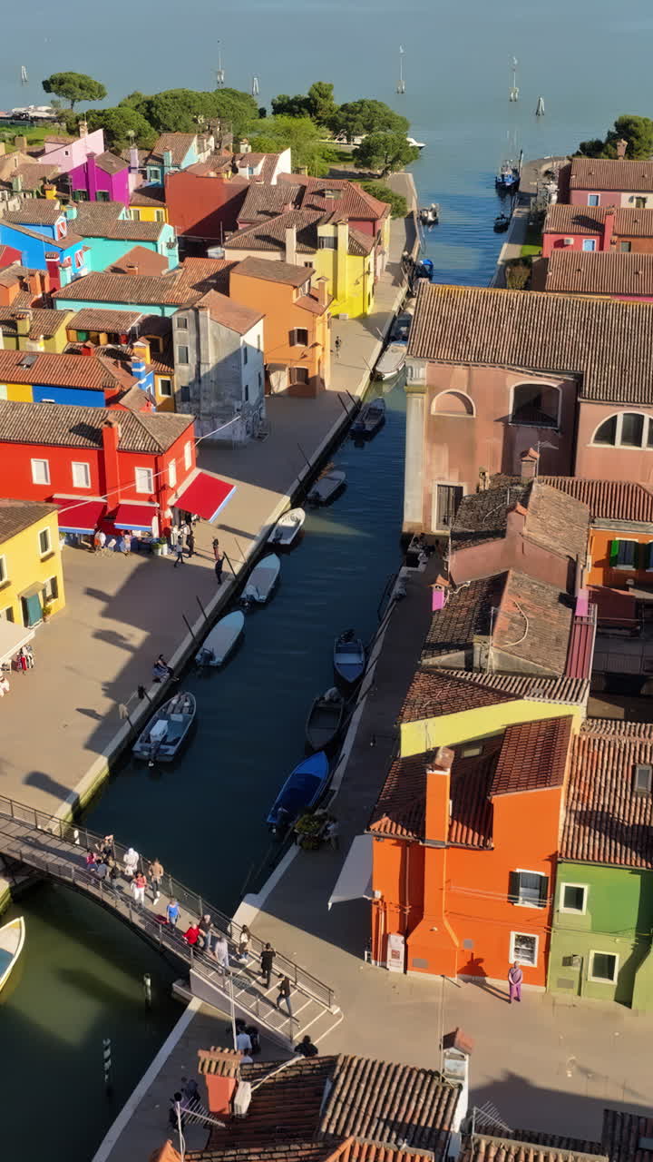 Aerial drone view of the colourful houses of Burano Island, Italy. Vertical