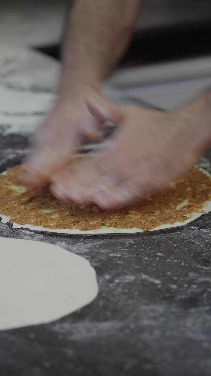 Chef Spreading Topping on Dough for Traditional Flatbread