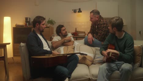 friends playing guitar at home