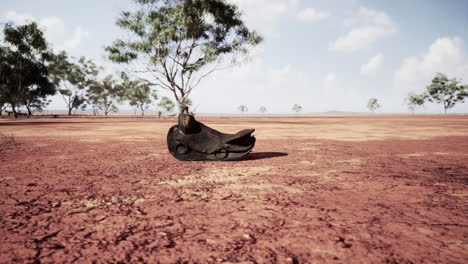 old decorated mexican saddle lying on sand